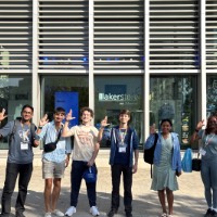 International Students Posing With Anchor UP Hand Sign in front of Laker Store